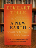 Load image into Gallery viewer, Close-up of front cover of &quot;A New Earth.&quot; In this book Tolle expands on ideas from his first book The Power of Now - &quot;powerful ideas to show how transcending our ego-based state of consciousness is not only essential to personal happiness, but also the key to ending conflict and suffering throughout the world. Tolle describes how our attachment to the ego creates the dysfunction. His message is simple - stay conscious - in the present moment and don&#39;t allow the mind to lead you away from it. Cost is $17.00
