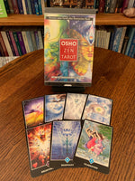 Load image into Gallery viewer, Osho Zen Tarot Deck is beautifully illustrated and an excellent all-around deck for receiving guidance on important questions or issues. The set includes 79 tarot cards (one more than the traditional 78 - the extra card is called &quot;The Master&quot;). This deck consists of the 56 minor arcana and 23 major arcana, but is not a traditional in some other ways - the extra card, the suits (e.g. clouds), etc. It was my go-to deck for many years. Price is $29.99. Photo shows 7 cards and the front of the deck box.
