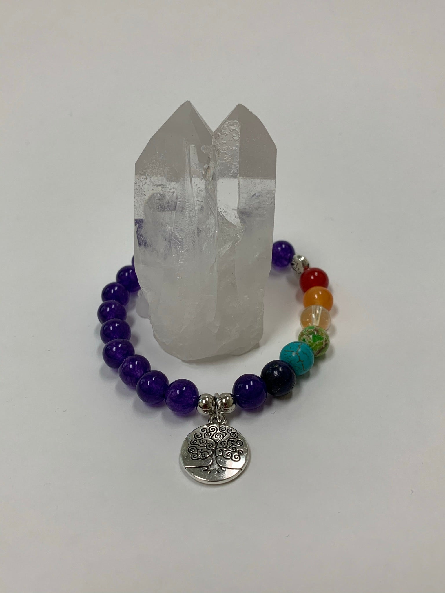 Power bracelet with all amethyst beads except 7 beads to match the chakras. Beads are 8mm. This bracelet also comes with a silver charm that has a tree of life etched in it in black. The beads are genuine but the color has been enhanced.  