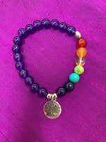 Load image into Gallery viewer, Second close-up of the power bracelet with all amethyst beads except 7 beads to match the chakras. Beads are 8mm. This bracelet also comes with a silver charm that has a tree of life etched in it in black. The beads are genuine but the color has been enhanced. 
