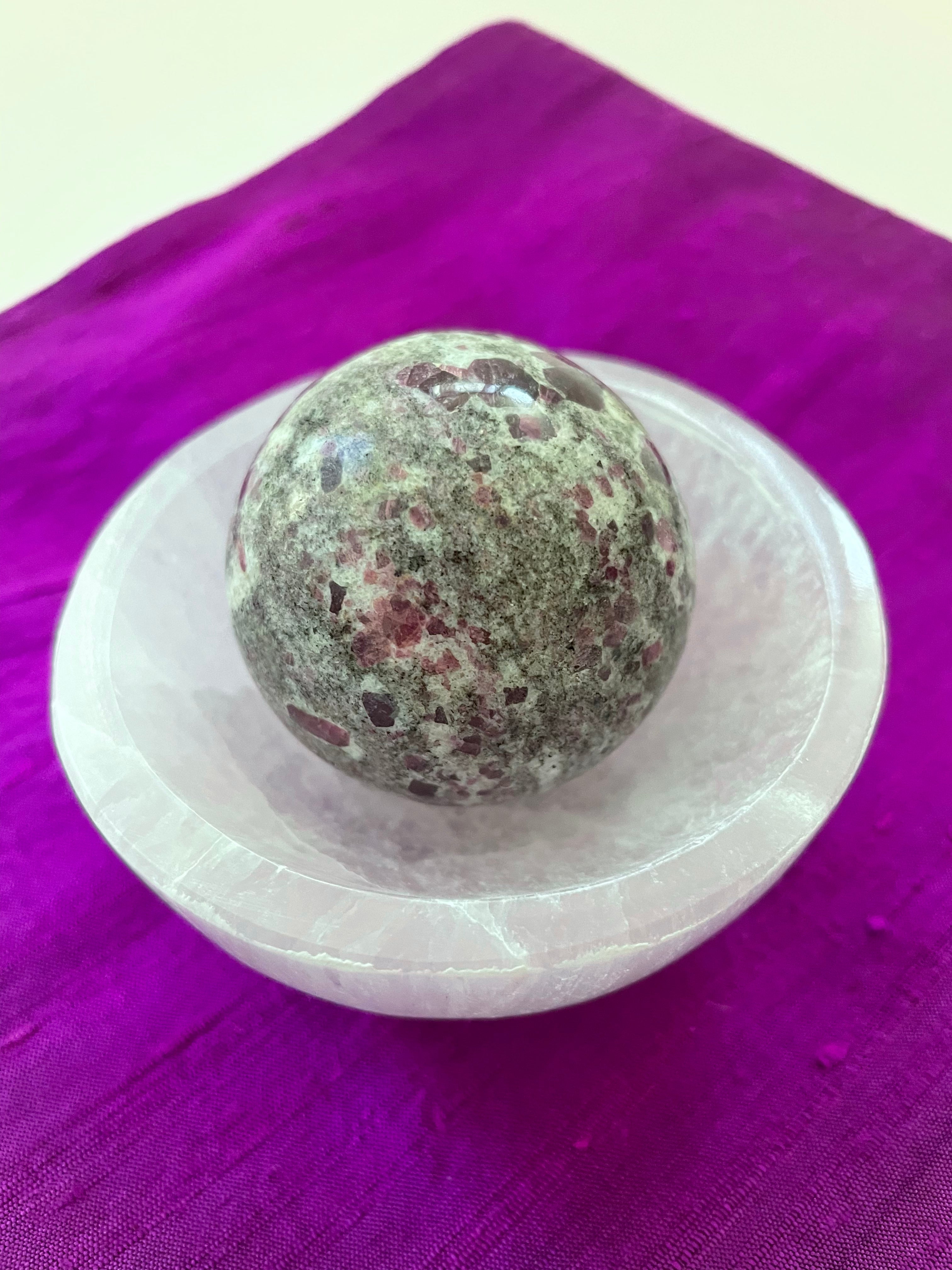 Alternate view. Ruby in matrix sphere is perfect for your altar, for meditation, as décor in your home or office. It consists of rubies set in their natural stone matrix. Ruby balances the heart, increases energy levels. It is a stone of love and passion and sexuality. It protects against psychic attack. It is a stone of prosperity and helps you to draw in abundance and maintain wealth. It enhances courage and leadership. This sphere weighs 5.2 oz. and is approximately 6" in circumference. $38.00.