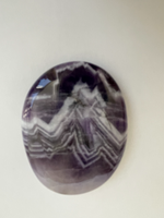 Load image into Gallery viewer, Alternate view. Love the banding on this palm stone. Beautiful amethyst palm stone can be used for meditation, healing, on your altar or as a décor item. Amethyst, one of the most spiritual gemstones, heals, cleanses &amp; calms, allowing you to reach meditative &amp; higher consciousness levels more easily. It also helps to dispel negative emotional states and more. Chevron amethyst is a combination of amethyst and white quartz and when you add the quartz you get additional qualities. Approx. 2&quot; long. Cost is $12.

