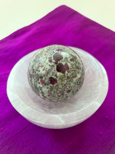 Alternate view. Ruby in matrix sphere is perfect for your altar, for meditation, as décor in your home or office. It consists of rubies set in their natural stone matrix. Ruby balances the heart, increases energy levels. It is a stone of love and passion and sexuality. It protects against psychic attack. It is a stone of prosperity and helps you to draw in abundance and maintain wealth. It enhances courage and leadership. This sphere weighs 5.2 oz. and is approximately 6" in circumference. $38.00.