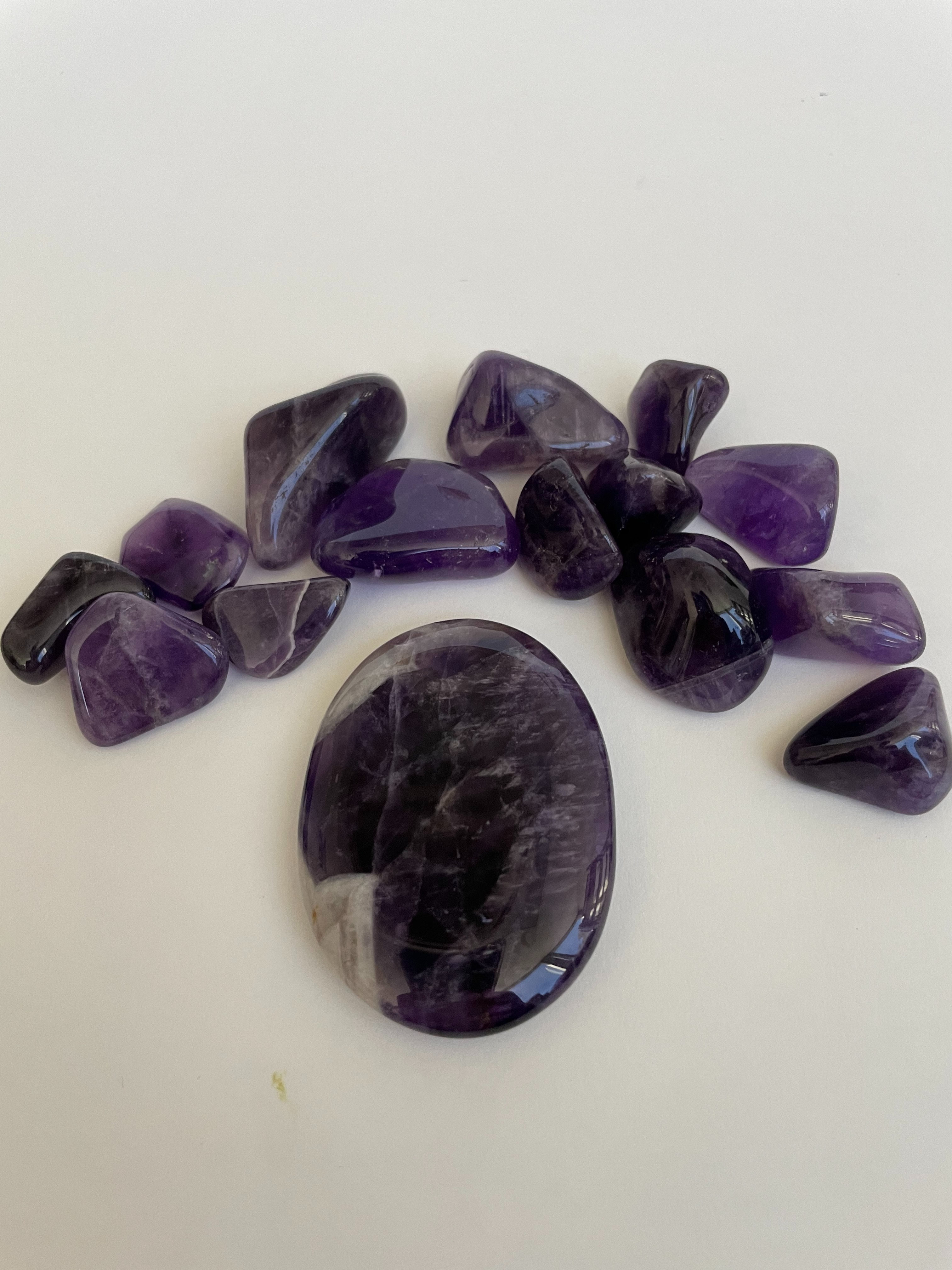 Chevron amethyst palm stone.  Beautiful amethyst palm stone can be used for meditation, healing, for your altar or as décor for any room in your home or office. Amethyst, one of the most spiritual gemstones, heals, cleanses & calms, allowing you to reach meditative & higher consciousness levels more easily. It also helps to dispel negative emotional states and more. Chevron amethyst is a combination of amethyst and white quartz and when you add the quartz you get additional qualities. 2" long. Cost is $12.