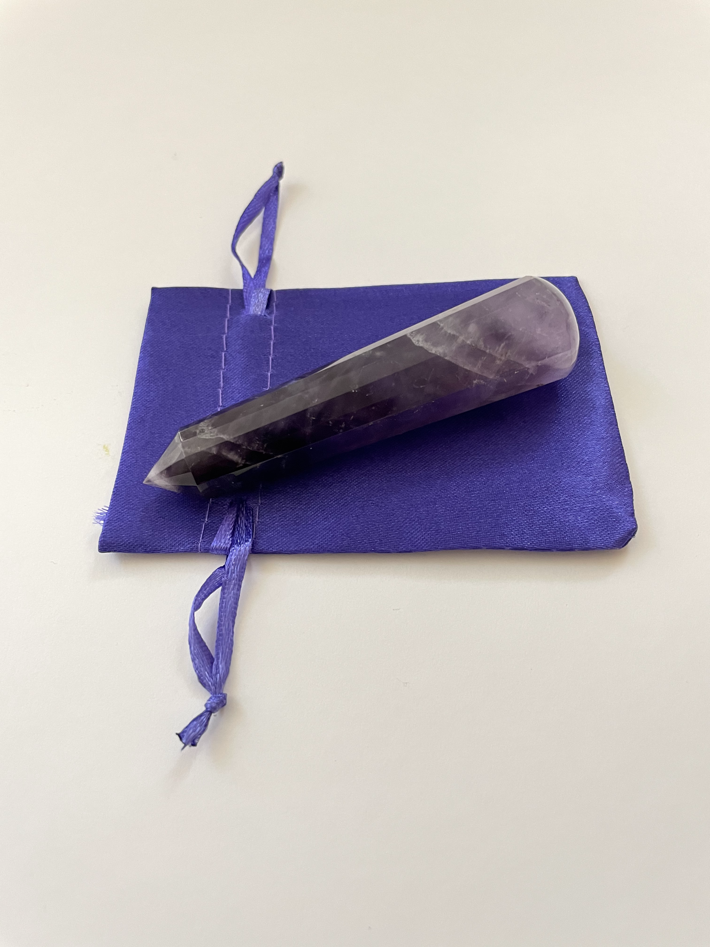 Alternate view. Gorgeous, 16-sided amethyst healing wand, with stunning craftsmanship. This high quality, deep purple amethyst wand can be used for healing and works especially well for "people recovering from any type of poor health - emotional, mental, physical or spiritual "and can aid in finding one's true path (ravenscrystals.com). It is approx. 3¾" long. Cost is $30.