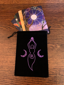 Lovely oracle/tarot deck bag with drawstrings for closure. Black faux-velvet with purple embroidered Moon goddess. She holds a small moon in her hands, above her head. There is a crescent moon on either side of her and a spiral on her lower body. This 7"x5" bag can hold almost any size oracle or tarot deck, but is best suited for larger decks (e.g. Medicine Cards). This bag can also be used to store large crystals or other precious items. Cost is $7.50