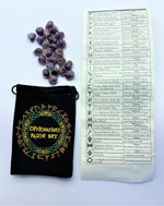 Load image into Gallery viewer, Amethyst Rune set with a runic symbol (in gold) on each stone. The set comes in a black bag embroidered on the front in green, yellow and light brown/gold with runic designs and the words &quot;Divination Rune Set.&quot; Comes with a rolled up sheet of paper displaying each rune and its meaning. 
