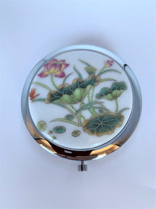 Great little compact mirror for purse or vanity. It is hinged with 2 mirrors.Aand the lotus adds a beautiful and spiritual touch. It is functional and also elegant. I keep mine out on my bathroom counter because it is so pretty to look at. The lotus flower is a sacred symbol reminding us that we all must push through the mud to get to the light. It stands for purity, strength and enlightenment.  It is approximately 2¾" across. Great gift, great price - $5.00.