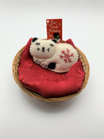 Load image into Gallery viewer, This is a cat Christmas ornament, curled up and sleeping.  It is handcrafted (fair trade) with 100% natural wool.  It is off-white with black accents (ears, tail, etc.) and has the &#39;signature&#39; red snowflake on her body. Approximately 3&quot;x4.25&quot; and comes with a detachable fair trade &quot;to/from&quot; tag to use if giving as a gift.
