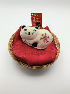 This is a cat Christmas ornament, curled up and sleeping.  It is handcrafted (fair trade) with 100% natural wool.  It is off-white with black accents (ears, tail, etc.) and has the 'signature' red snowflake on her body. Approximately 3"x4.25" and comes with a detachable fair trade "to/from" tag to use if giving as a gift.