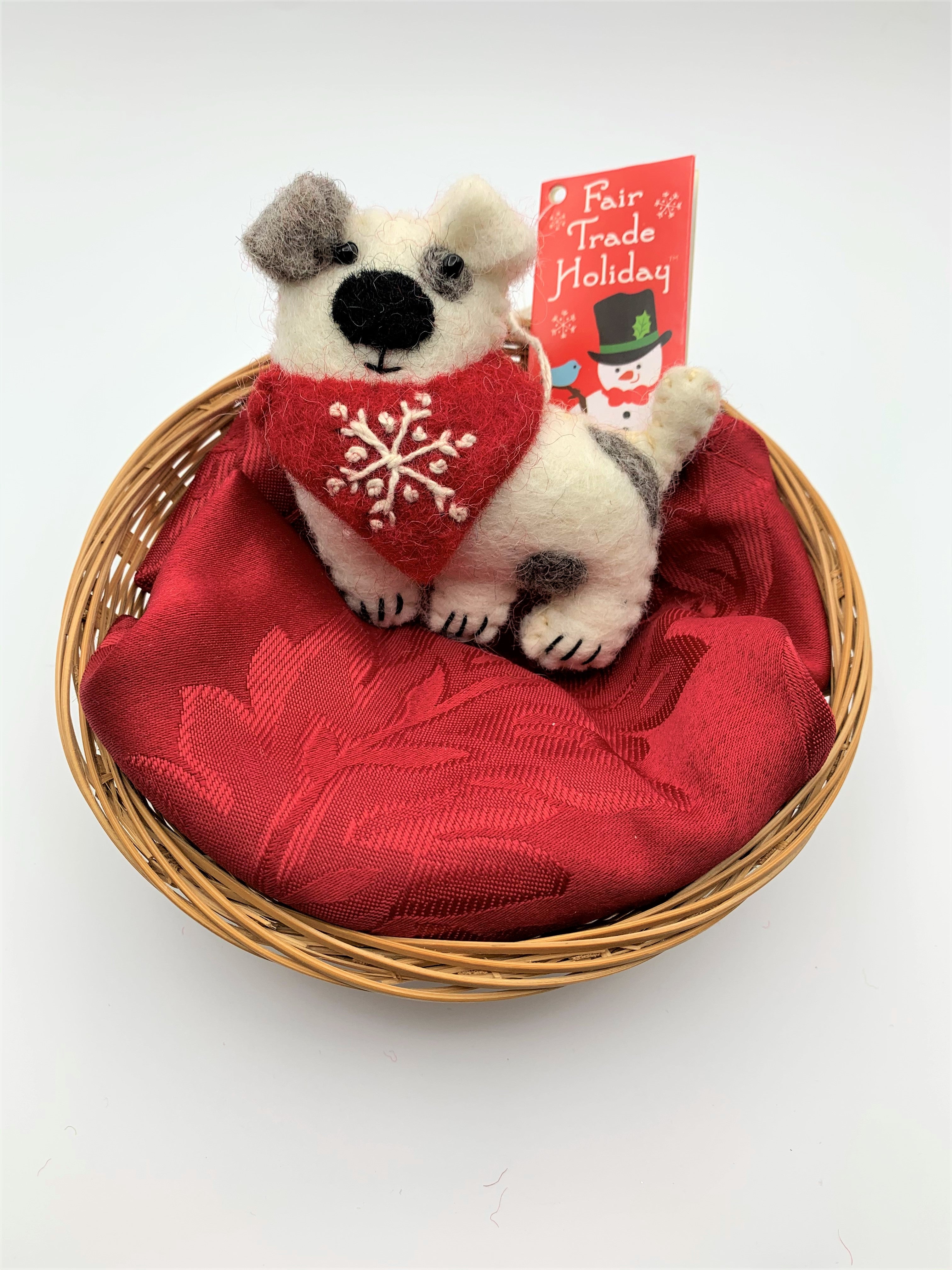 Patches the dog is a hand-crafted (fair trade) Christmas ornament made of 100% natural wool. He is white with brown patches and a red bandana with a 'signature' (white) snowflake on it. Approximately 3.75"x3.75".  He comes with a detachable fair trade holiday tag to use if you are giving as a gift.
