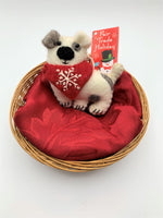 Load image into Gallery viewer, Patches the dog is a hand-crafted (fair trade) Christmas ornament made of 100% natural wool. He is white with brown patches and a red bandana with a &#39;signature&#39; (white) snowflake on it. Approximately 3.75&quot;x3.75&quot;.  He comes with a detachable fair trade holiday tag to use if you are giving as a gift.
