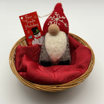 Load image into Gallery viewer, This is a gnome Christmas ornament and is handcrafted (fair trade) and made of 100% natural wool.  It has a brownish-gray body, a long white beard, a round nose and a pointed red hat with the &#39;signature&#39; (white) snowflake on it and there are no visible eyes as the hat covers that area.   Approximately 5.5&quot;x2.5&quot; and comes with a detachable fair trade holiday &quot;to/from&quot; tag to use  if you are giving this as a gift.
