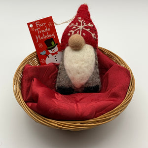 This is a gnome Christmas ornament and is handcrafted (fair trade) and made of 100% natural wool.  It has a brownish-gray body, a long white beard, a round nose and a pointed red hat with the 'signature' (white) snowflake on it and there are no visible eyes as the hat covers that area.   Approximately 5.5"x2.5" and comes with a detachable fair trade holiday "to/from" tag to use  if you are giving this as a gift.