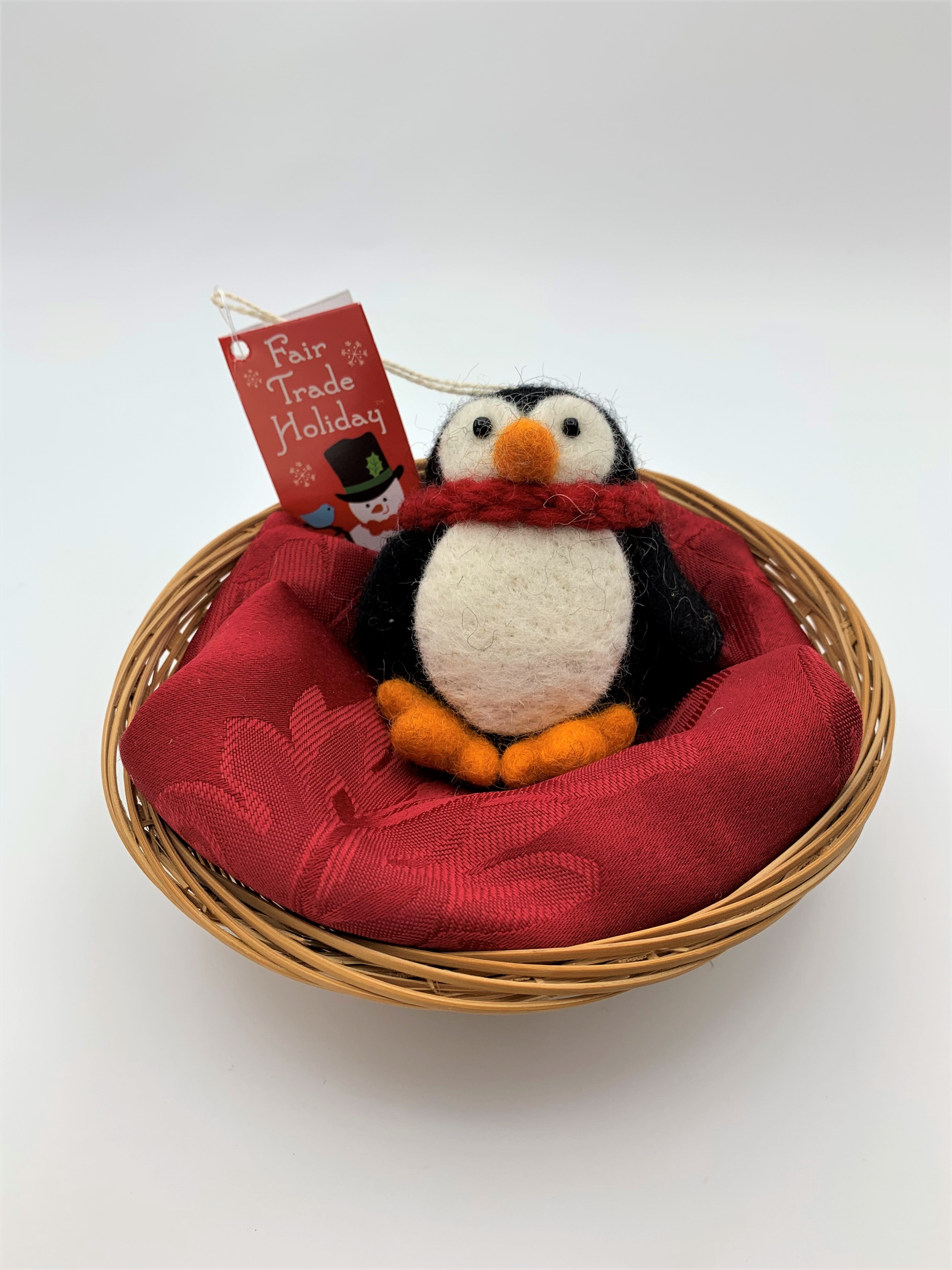 This the Pokey penguin Christmas ornament.  It is handcrafted (fair trade), made of 100% hand-felted natural wool, is black and white and a little chubby, with an orange beak and feet, wearing a red winter scarf. Approximately 3.5"x3".  He comes with a detachable fair trade holiday tag to use if you are giving this as a gift. 