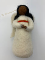 Load image into Gallery viewer, This is an close-up photo of an angel of color (black) Christmas ornament that is handcrafted (fair trade) and made of 100% natural wool. She wears a white dress accented with red and gold beading on empire waist, has a gold beaded halo, black face and hair and bendable arms. Approximately 5&quot;x2.5&quot;. She comes with a fair trade holiday &quot;to/from&quot; tag to use if giving this as a gift.
