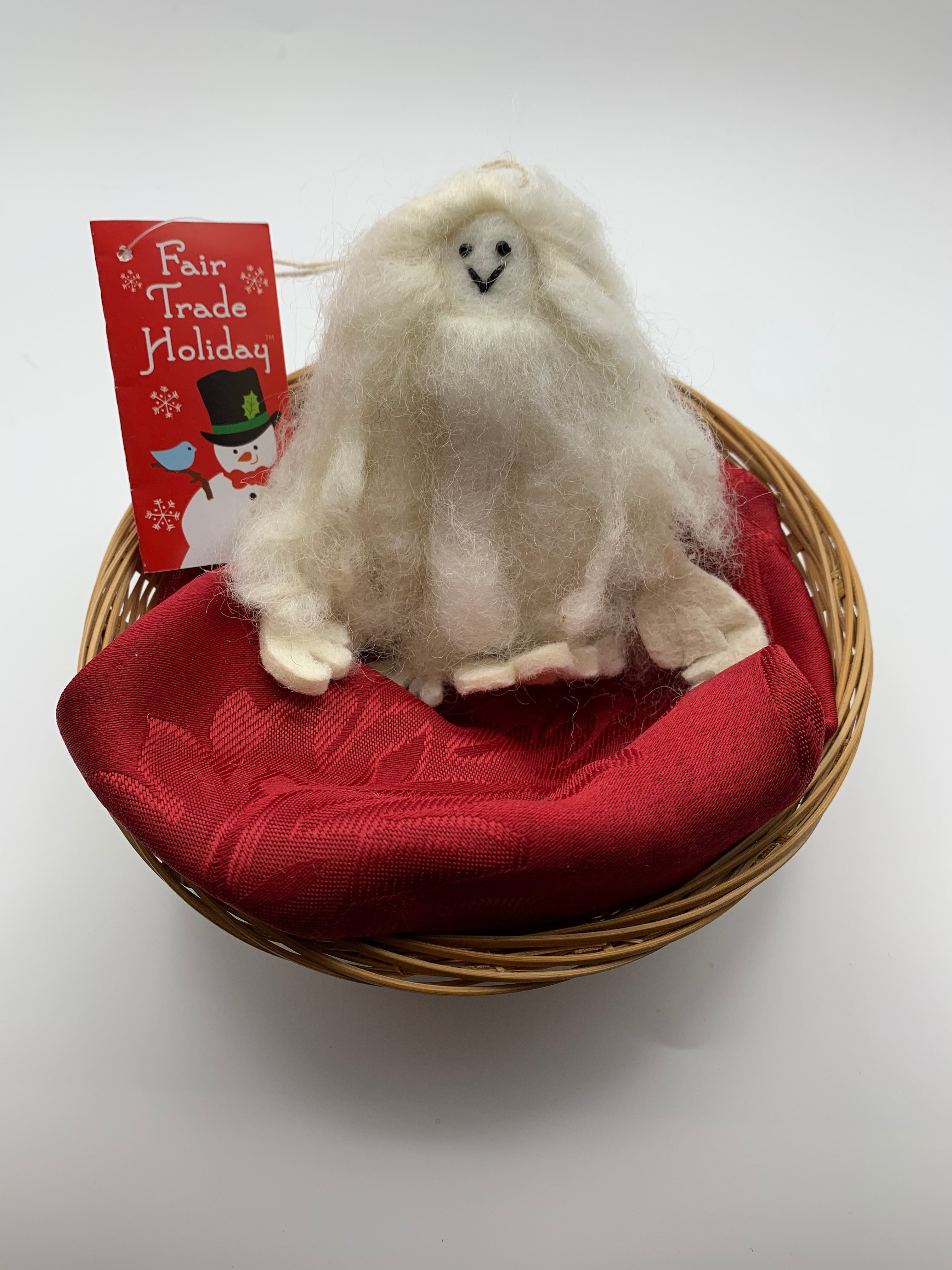This is a Yeti Christmas Ornament that is handcrafted (fair trade) and made of 100% natural wool.  He is off-white and furry with felted hands and feet and black accents (mouth/eyes). Approximately 4.5"x3.5". He comes with a fair trade holiday "to/from" tag to use if you are giving this as a gift.