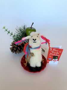 This sledding llama Christmas ornament is handcrafted (fair trade) and is made of 100% natural, hand-felted wool.  The sled is handmade using paper and feels something like very thin wood. The llama is furry, off-white and brown, with black accents (hooves, facial features), sits on a round red sled and wears a scarf made of colorful (red, blue and pink) yarn.  The same yarn is used for accents on its ears.  Approximately 4.5"x2.75"x2.75".