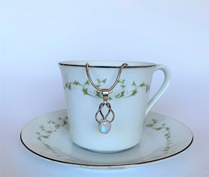 This is a sterling silver love knot pendant (2 strands) with a beautiful moonstone at the bottom. The necklace chain is not included.  Pendant is lightweight and is approximately 1¾" long. Necklace chain not included.