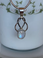 Load image into Gallery viewer, Close-up view. This is a sterling silver love knot pendant (2 strands) with a beautiful moonstone at the bottom. The necklace chain is not included. Pendant is lightweight and is approximately 1¾&quot; long. Necklace chain not included.

