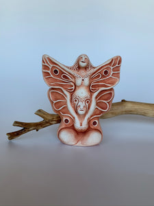 This lovely sacred art sculpture is entitled "Butterfly,"  a clay sculpture in browns & tans depicting a woman rejoicing, her butterfly wings extended. In the lower part of her body is a woman's face, arms and chest area bursting upward (she has antennae). Beautiful and intricate! Butterfly is all about transformation  Emerging can be be unsettling, but also bring joy, life and the freedom of flight. The Sculpture is approximately 3.5" tall. 