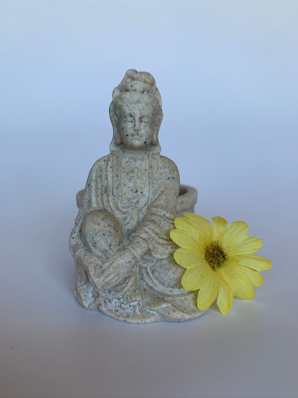 Beautiful sandstone Kwan Yin candle holder - a welcome addition to your altar, mediation space or simply to add to the décor of your home. Add a votive candle to increase the ambiance or to use as a focus during spiritual practice. Kwan Yin is a revered and powerful goddess. She symbolizes compassion, mercy and kindness. Approximately 3¼" tall.