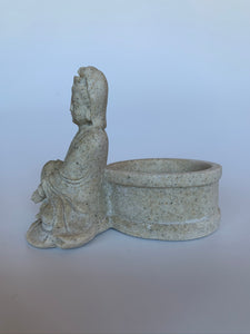 Side View. Beautiful sandstone Kwan Yin candle holder - a welcome addition to your altar, mediation space or simply to add to the décor of your home. Add a votive candle to increase the ambiance or to use as a focus during spiritual practice. Kwan Yin is a revered and powerful goddess. She symbolizes compassion, mercy and kindness. Approximately 3¼" tall.
