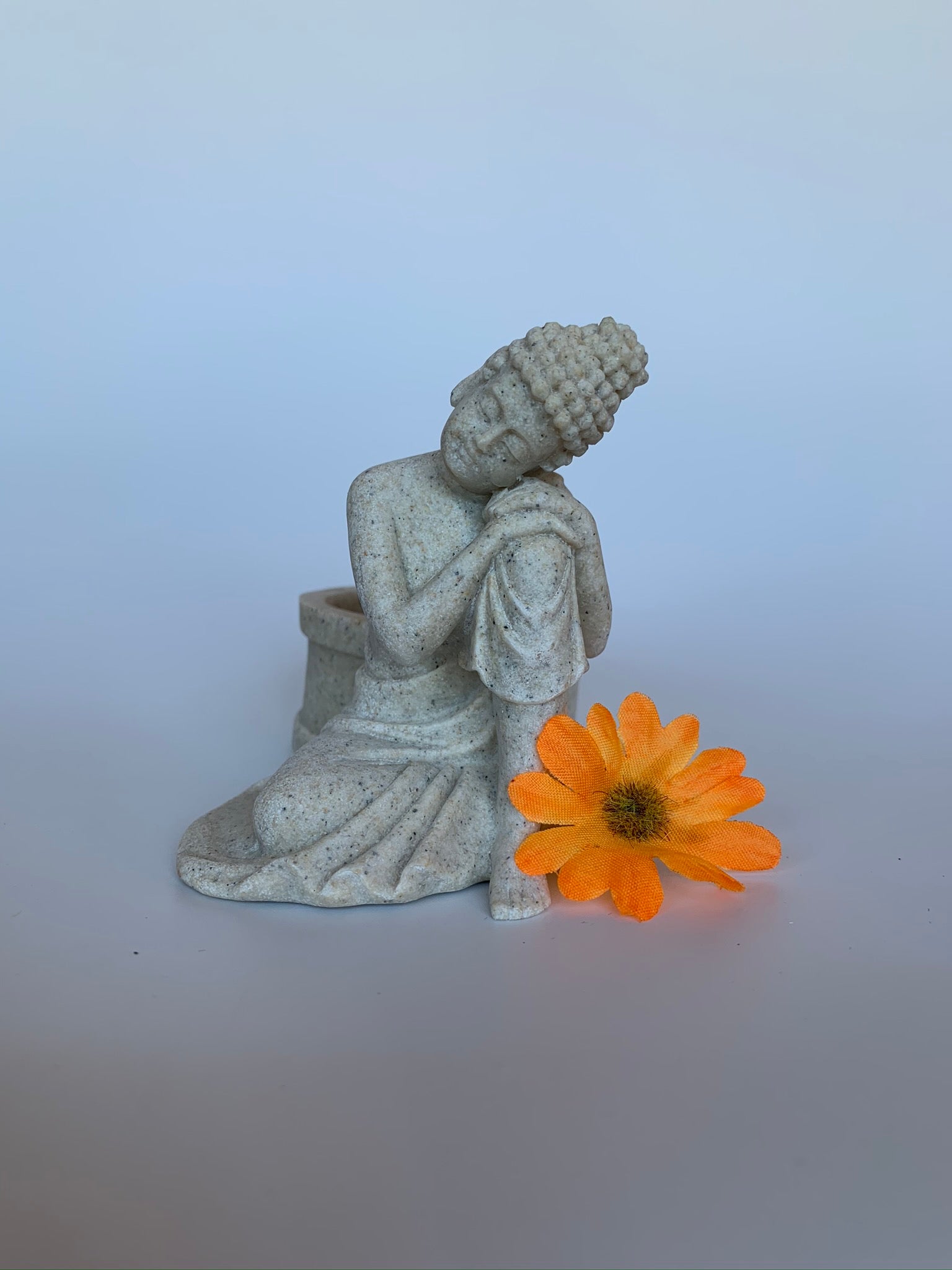 Beautiful sandstone Buddha candle holder - a welcome addition to your altar, mediation space or simply to add to the décor of your home. Add a votive candle to increase the ambiance or to use as a focus during spiritual practice. Buddha is revered around the world and his teachings and actions have shown us the beauty, wonder and power of enlightenment. The term Buddha refers to the Awakened One. Size is approximately 3¼" tall.