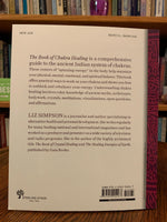Load image into Gallery viewer, Back cover. The Book of Chakra Healing by Liz Simpson is a &quot;comprehensive guide to the ancient Indian System of chakras.&quot; Simpson discusses each of the chakras and how to unblock them and move into a more balanced energy. Liz Simpson is a journalist and author who focuses on alternative healing and personal development. She writes for many national and international magazines as well. Cost is $14.95
