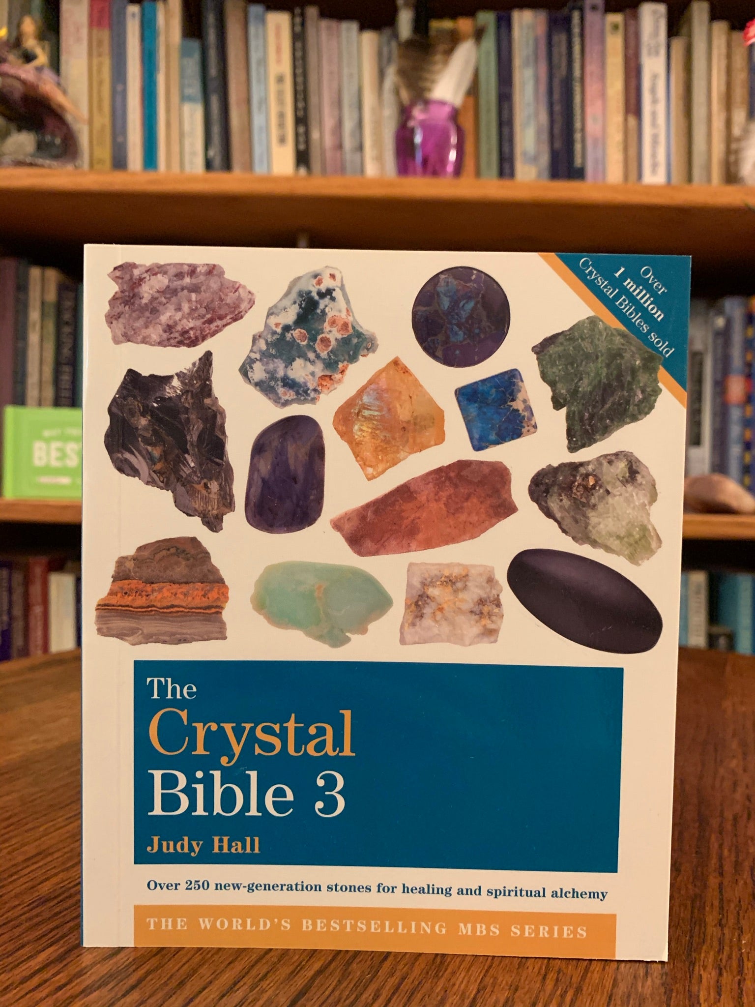 Close-up view front cover. The Crystal Bible 3 is the third comprehensive book about crystals and gemstones by Judy Hall, including 250 additional crystals. It is 400 pages long and made with high quality paper. Most of the book is devoted to in depth descriptions of the esoteric and practical properties of stones and crystals, but she also includes sections on crystal vibrations, crystal skulls and more. She has written three separate volumes of her crystal Bible books and also a book on crystal healing.