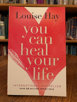 Load image into Gallery viewer, Close-up Front Cover. You Can Heal Your Life by the amazing Louise Hay. This is one of the first books I ever read as I transformed my own life spiritually and re-oriented my belief about healing to a holistic and natural approach. It is a wonderful book with profound information about healing, self-healing and self-love, in which Hay tells her own story of transformation and healing and of how she beat cancer in natural ways. Cost is $15.99.
