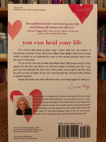 Load image into Gallery viewer, Close-up back Cover. You Can Heal Your Life by the amazing Louise Hay. This is one of the first books I ever read as I transformed my own life spiritually and re-oriented my belief about healing to a holistic and natural approach. It is a wonderful book with profound information about healing, self-healing and self-love, in which Hay tells her own story of transformation and healing and of how she beat cancer in natural ways. Cost is $15.99.

