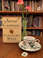 Load image into Gallery viewer, Sacred Contracts by Caroline Myss is a powerful book and guide to finding your own sacred contracts (higher purpose) using archetypes that &quot;build on the works of Jung, Plato&quot; and others. In coming to know your archetypal companions, you also begin to see how to live your life in ways that make the best use of your personal power and lead you to fulfill your greatest - in fact, your divine - potential.&quot; Myss is a best-selling author, medical intuitive and spiritual teacher. Cost is $17.99.
