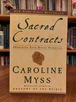 Load image into Gallery viewer, Front cover. Sacred Contracts by Caroline Myss is a powerful book and guide to finding your own sacred contracts (higher purpose) using archetypes that &quot;build on the works of Jung, Plato&quot; and others. In coming to know your archetypal companions, you also begin to see how to live your life in ways that make the best use of your personal power and lead you to fulfill your greatest - in fact, your divine - potential.&quot; Myss is a best-selling author, medical intuitive and spiritual teacher. Cost is $17.99
