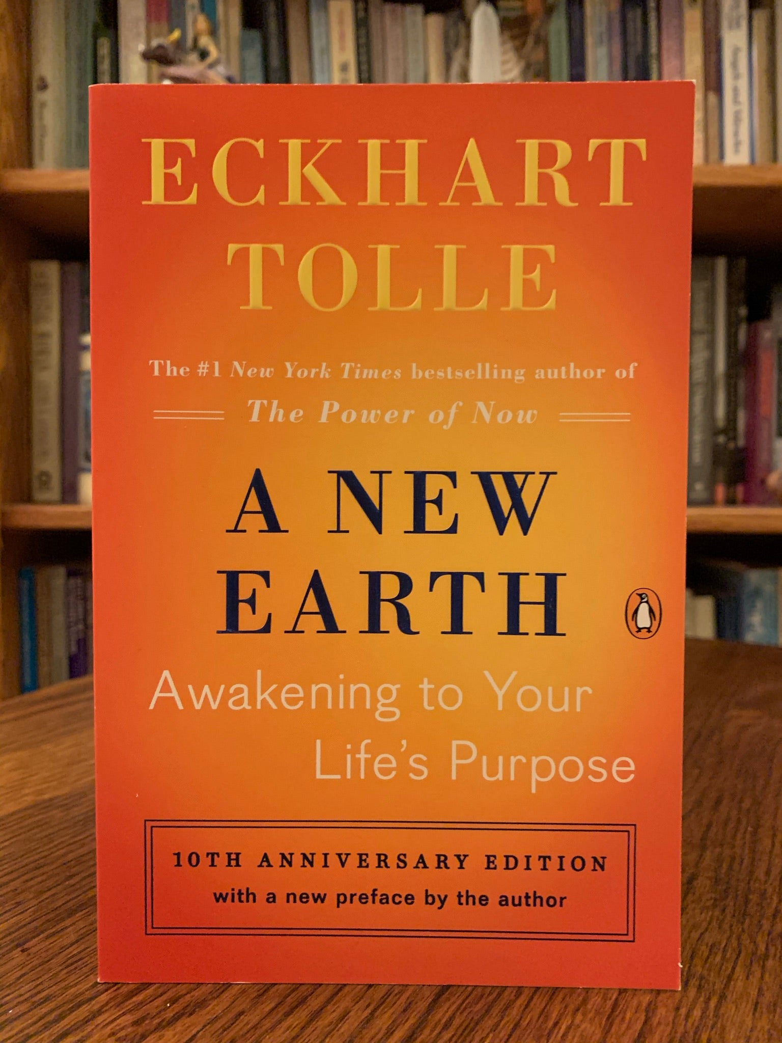 Close-up of front cover of "A New Earth." In this book Tolle expands on ideas from his first book The Power of Now - "powerful ideas to show how transcending our ego-based state of consciousness is not only essential to personal happiness, but also the key to ending conflict and suffering throughout the world. Tolle describes how our attachment to the ego creates the dysfunction. His message is simple - stay conscious - in the present moment and don't allow the mind to lead you away from it. Cost is $17.00