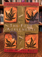 Load image into Gallery viewer, Close-up front cover. Based on ancient Toltec Wisdom, The Four Agreements by don Miguel Ruiz, guides us to a personal and spiritual transformation using four simple words and their power, meaning and call to &quot;action.&quot; &quot;In the tradition of Casteneda, Ruiz distills essential Toltec wisdom, expressing with clarity and impeccability, what it means for men and women to live as peaceful warriors in the modern world (Dan Milllman, author of Way of the Peaceful Warrior). Cost is $12.95

