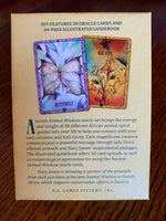 Load image into Gallery viewer, Photo of box back. The Ancient Animal Wisdom Deck and Book Set is beautifully illustrated - very colorful and visually appealing. What I find very special about this deck is that a) all of the animals are ones found in Africa (mostly in Zambia) and b) underneath the English name for the animal, you will find the African name, which I love! I also like the fact that, in the guidebook, they include information about numerology. The set includes 38 cards, a guidebook &amp; box for storage. Cost is $22.95.
