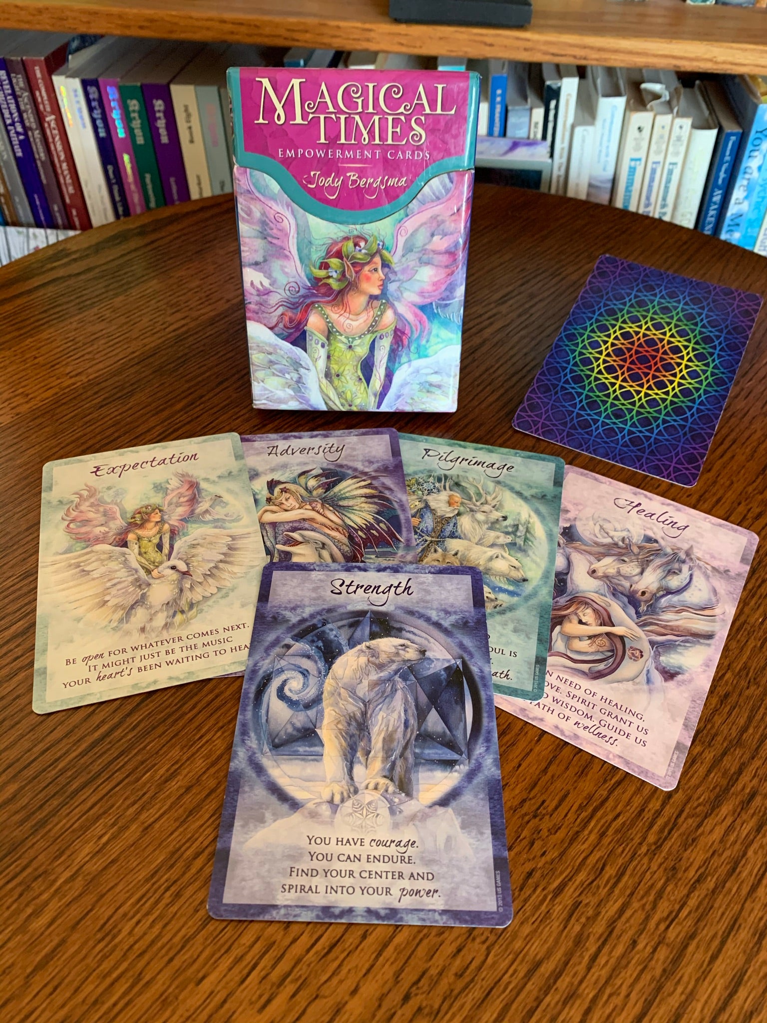 Magical Times Empowerment Cards consist of 44 beautifully illustrated cards by the artist, Jody Bergsma, a small, paper guide booklet and a very nice box for storage. You can use these cards as a regular oracle deck or for simply choosing a message with an affirmation for your day, week or month. I love this deck and like to follow up every reading with one of these wonderful cards. This photo is a display of 5 of the cards, the back of one of the cards and the box front. Price is $19.95.