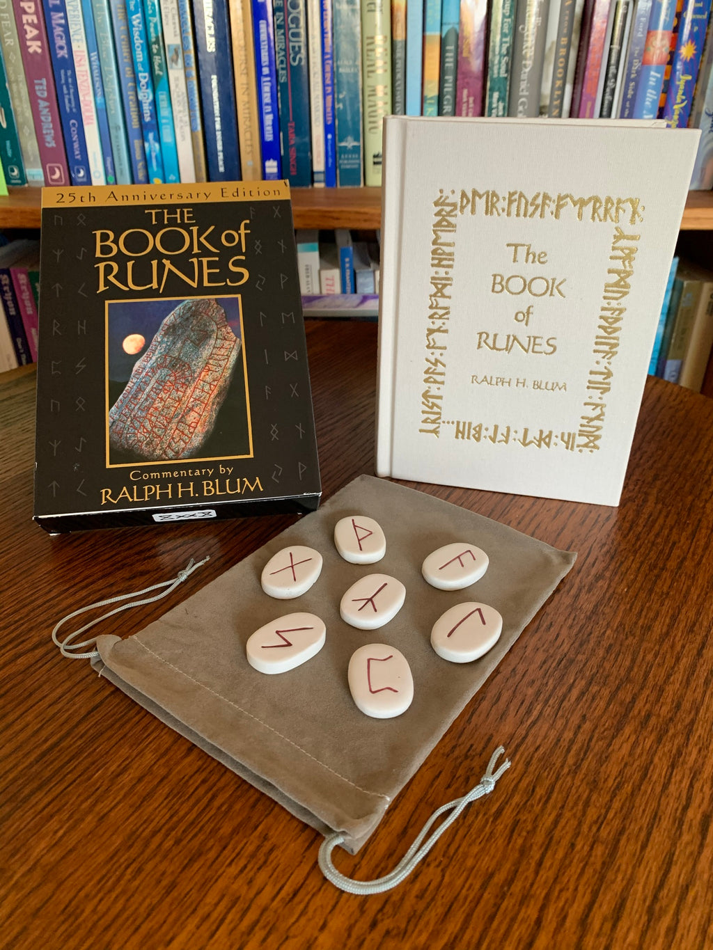 The Book of Runes by Ralph Blum has been around for many years. I have used this set for a very long time. He is the person who is credited (or criticized) for adding the blank rune to the original set of 24, making it 25. The set comes with a set of 25 large rune stones, a bag to store them in and a hardback guidebook. The photo shows the deck box, runes, bag and guidebook. Price is $37.50.