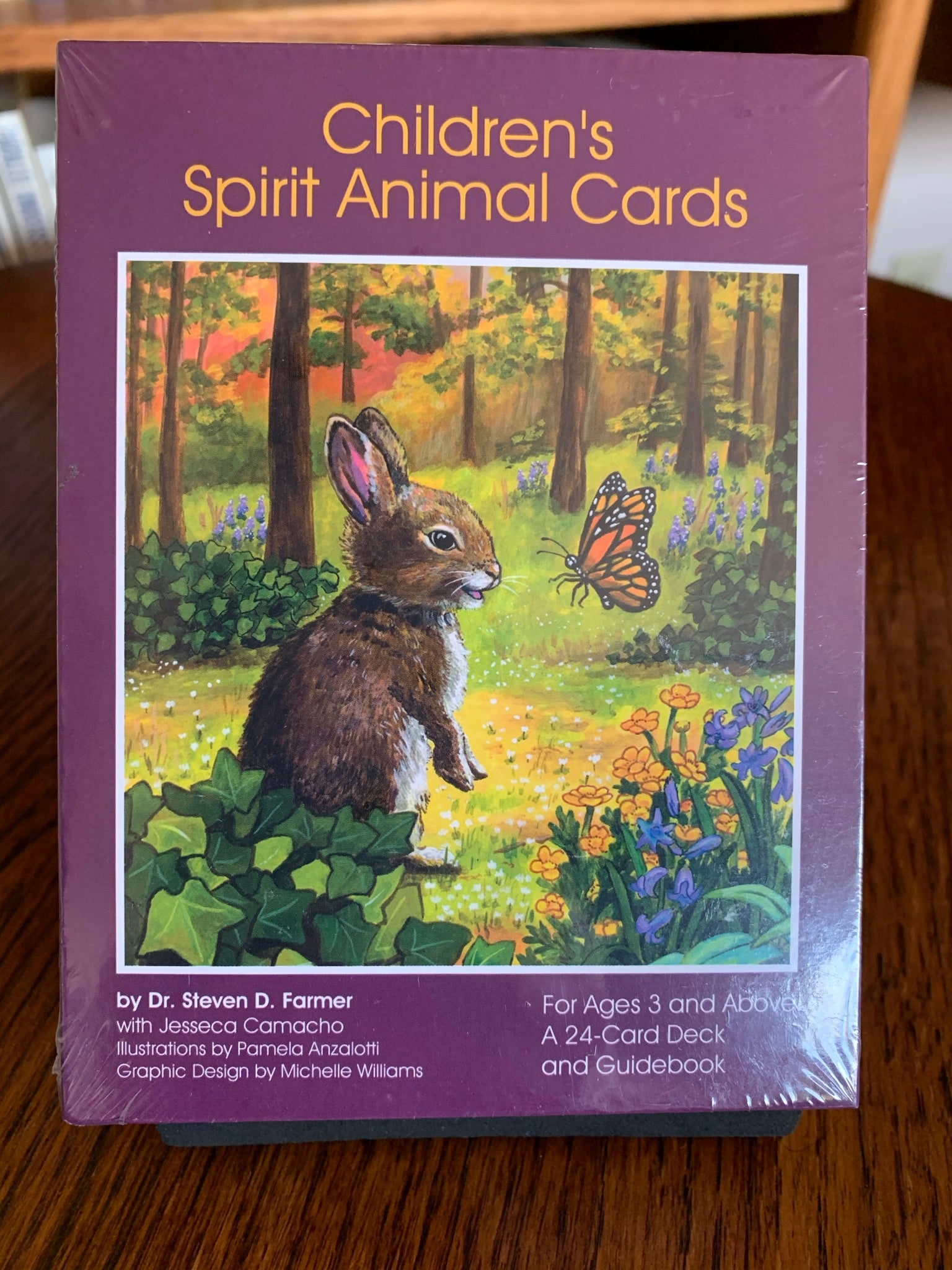 Photo of box front. Children's Spirit Animal Cards, with their colorful and inspiring illustrations give children the chance to choose cards and gain insights without the complexities of adult oracle cards. It also opens children up to the idea of spirit animals and the powerful messages they bring with simple words or phrases and artwork that they will love. Set consists of 24 oracle cards, guidebook (with guidance for parents) and a box for storage. Cost is $15.99