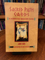 Load image into Gallery viewer, Photo of box front. The Sacred Path Cards is a wonderful deck created using sacred understandings and teachings in the Native American spiritual tradition. &quot;This unique system distills the essential wisdom of the sacred teachings of many tribal traditions and shows users the way to transform their lives. The author is Jamie Sams, who is a sacred Medicine teacher. she is of Iroquois and Cherokee descent. Set includes 44 cards, a hardback guidebook &amp; a box for storage. Cost is $37.50.
