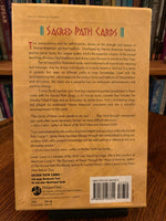 Load image into Gallery viewer, Photo of box back. The Sacred Path Cards is a wonderful deck created using sacred understandings and teachings in the Native American spiritual tradition. &quot;This unique system distills the essential wisdom of the sacred teachings of many tribal traditions and shows users the way to transform their lives. The author is Jamie Sams, who is a sacred Medicine teacher. she is of Iroquois and Cherokee descent. Set includes 44 cards, a hardback guidebook &amp; a box for storage. Cost is $37.50.
