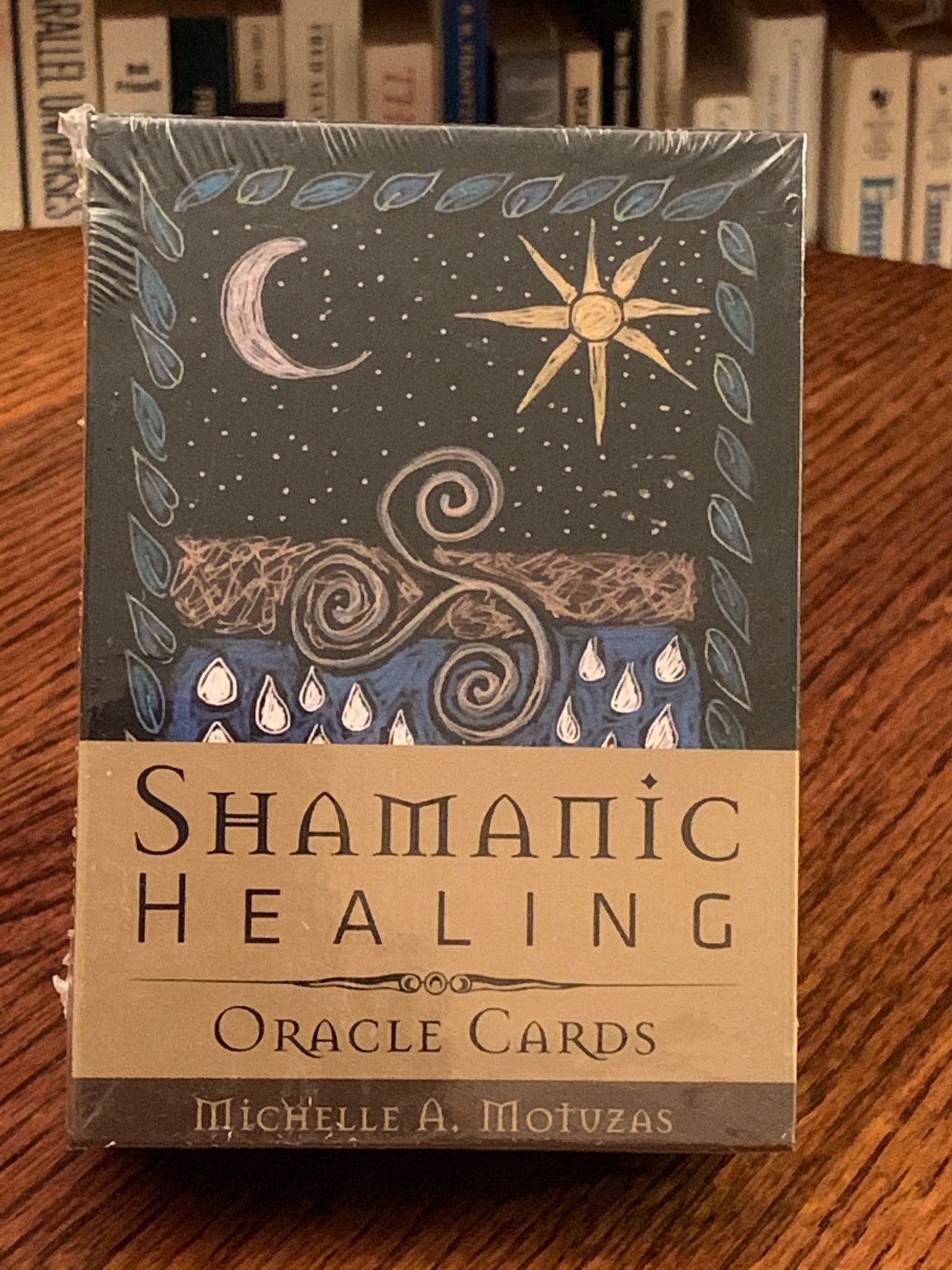 Photo of box front. The Shamanic Healing Oracle Cards bring you beautifully drawn illustrations and messages from Shamanistic traditions. The messages are simple, yet profound and the drawings are earthy and endearing. "Whether a novice or skilled reader, the messages found in these cards and the accompanying guidebook will give you insight, personal empowerment, and trust in your own intuitive abilities." The set is has 44 gold gilded cards, a guidebook and box that is magnetized. Cost is $24.99.