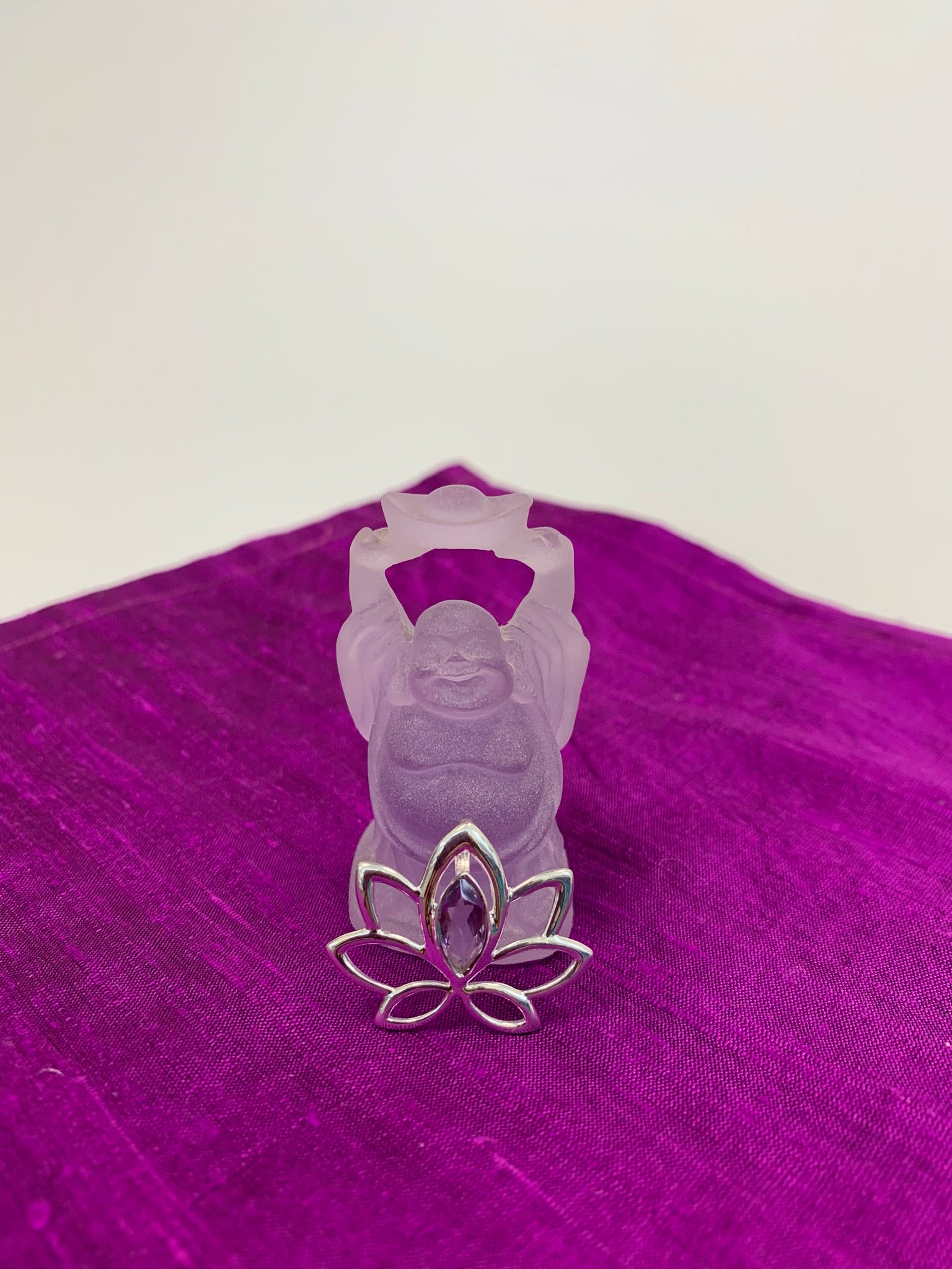 Marquise shaped amethyst set at the top of an open sterling silver lotus.  Pendant only, no necklace chain.  This lovely pendant is lightweight and approximately 1" long.  