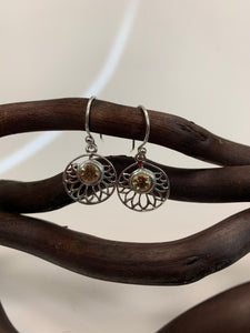 Round, faceted citrine gemstones are set at the top of an open sterling silver lotus flower, which itself is set in a circle of sterling silver.  These earrings are lightweight, have wires, not posts and are approximately 1½" long. 