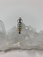 Load image into Gallery viewer, Chakra energy link pendant. Small faceted stones that represent each of the chakras: amethyst/crown, iolite/third eye, blue topaz/throat, peridot/heart, citrine/solar plexus, carnelian/sacral (or naval), garnet/root (or base). These stones, set in links or loops of sterling silver, two per loop or link, go straight down the middle. Pendant is approximately 1¾&quot;.
