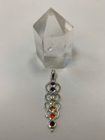 Load image into Gallery viewer, Another view of Chakra energy link pendant. Small faceted stones that represent each of the chakras: amethyst/crown, iolite/third eye, blue topaz/throat, peridot/heart, citrine/solar plexus, carnelian/sacral (or naval), garnet/root (or base). These stones, set in links or loops of sterling silver, two per loop or link, go straight down the middle. Pendant is approximately 1¾&quot;.
