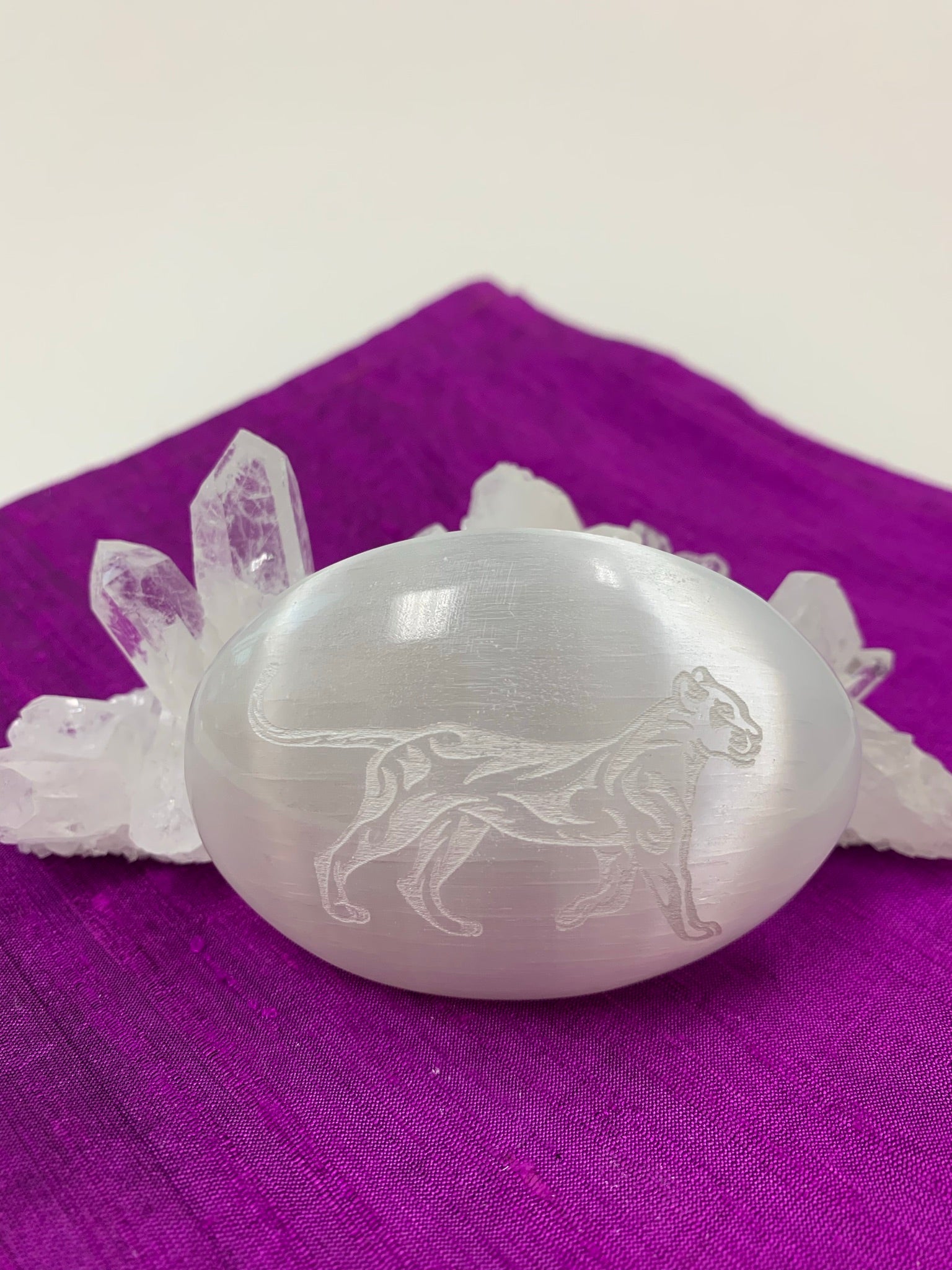 Lioness etched on white, polished selenite palm stone from our spirit animal collection. Lioness embodies the goddess & divine feminine and is related to The Great Mother. She is also seen as a protector, provider and as resourceful. She is the nurturer and fierce protector. The selenite ranges from translucent to milky white depending on the stone. Selenite is sourced ethically and workers are paid living wages. 