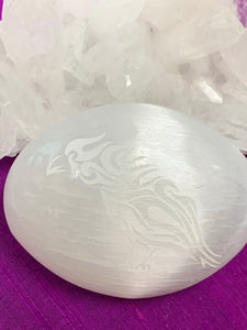 Raven etched on smooth, polished selenite palm stone. Selenite ranges from translucent to milky white and is the perfect size to fit in your palm. Average weight is 4.2 oz and it is approximately 3"x2.5". This selenite is ethically sourced and workers receive living wages.