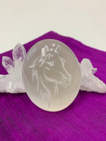 Load image into Gallery viewer, Horse (head and mane) etched on smooth, polished white selenite. Selenite ranges from translucent to milky white in color. Horse represents power and the use of wisdom with power. These selenite stones vary in weight, but the average is 4.2 oz. and size is approximately 3&quot;X2.5&quot;. These selenite stones are ethically sourced and workers earn living wages.  

